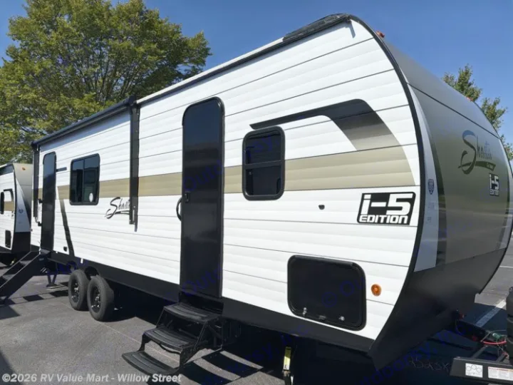 This white and black Shasta I-5 Edition travel trailer with a beige stripe is an ideal rv rental for your next road trip adventure.. Coachmen Shasta 2027