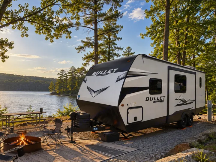 Lakeside rv rental camping with a Bullet Crossfire travel trailer, campfire, and beautiful sunset.. Keystone RV Bullet Crossfire 2024
