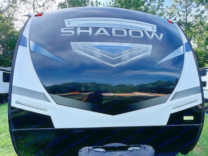 Exterior front of a "Shadow" RV rental, displaying its bold black and white design with blue accents.. Cruiser RV Shadow Cruiser 2022