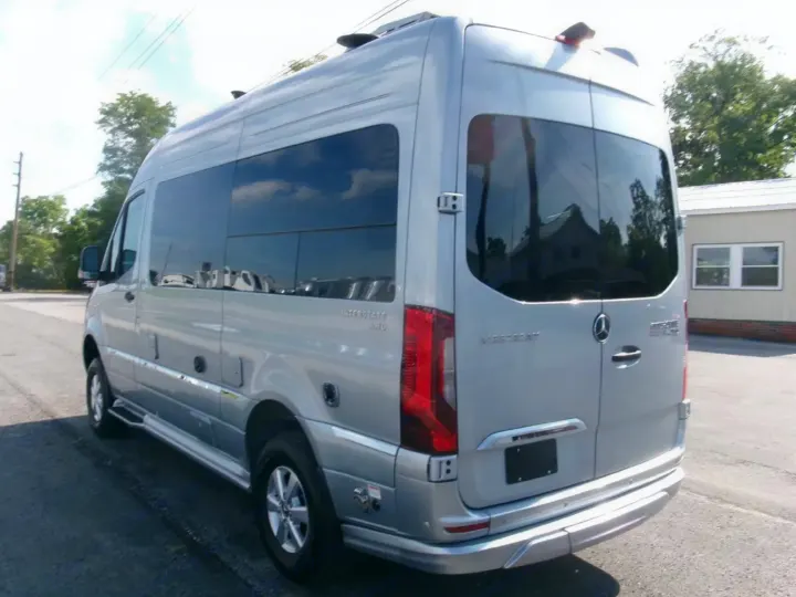 Silver Airstream Interstate RV rental, a spacious Mercedes-Benz Sprinter motorhome, shown parked from the rear-side.. Airstream Interstate 2026