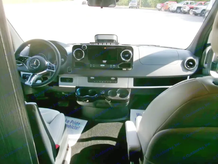 Inside a Mercedes rv rental: modern dashboard with infotainment screen, steering wheel, and comfortable front seats. Ready for adventure.. Airstream Interstate 2026