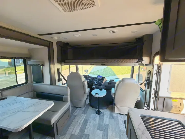 RV rental's inviting interior: driver's cabin, dinette, and cozy overhead bunk.. FR3 FR3 Motorhome 2022