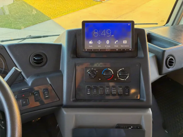 RV rental dashboard showing a Sony stereo (8:49 AM), climate controls, and rocker switches for mirror heat, shades, and speakers.. FR3 FR3 Motorhome 2022