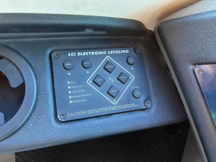This RV rental's LCI Electronic Leveling system panel shows auto/manual jack controls and various status indicators.. FR3 FR3 Motorhome 2022