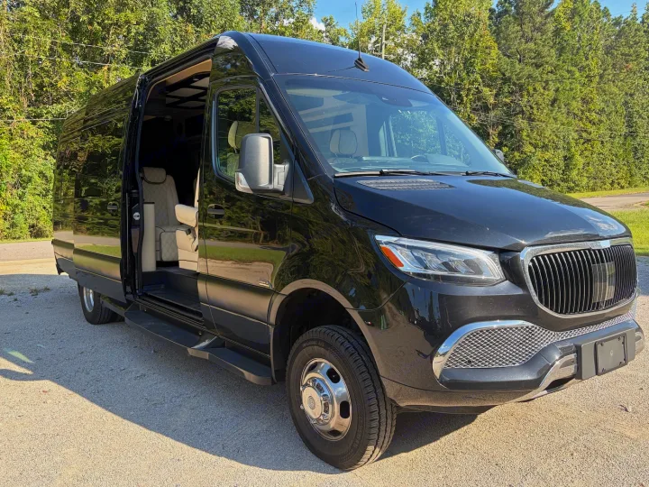 Experience comfort: Black Mercedes-Benz Sprinter van with open door revealing custom interior, ideal for rv rental trips.. Midwest Automotive Designs Luxe Cruiser 2025