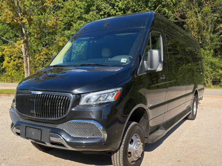 Sleek black Mercedes-Benz Sprinter luxury van, perfect for an rv rental adventure. Parked outside on a sunny day.. Midwest Automotive Designs Luxe Cruiser 2025