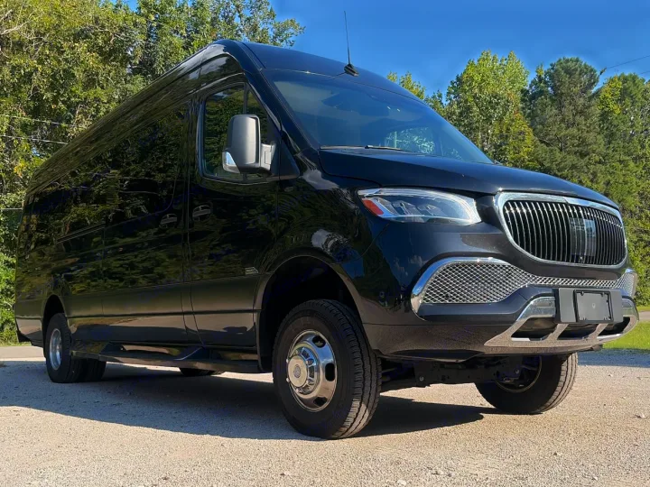 Sleek black Mercedes-Benz Sprinter conversion van, perfect for RV rental. Chrome details, shining on gravel.. Midwest Automotive Designs Luxe Cruiser 2025