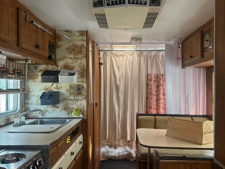 Step inside this charming RV rental: vintage kitchenette, cozy dinette, and classic wallpaper. Ready for your adventure.. Winnebago Winnebago 1980
