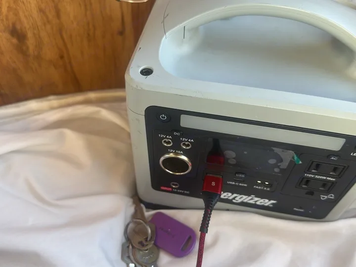 Energizer portable power station connected via USB-C, with keys nearby. Perfect charging gear for an RV rental adventure.. Winnebago Winnebago 1980