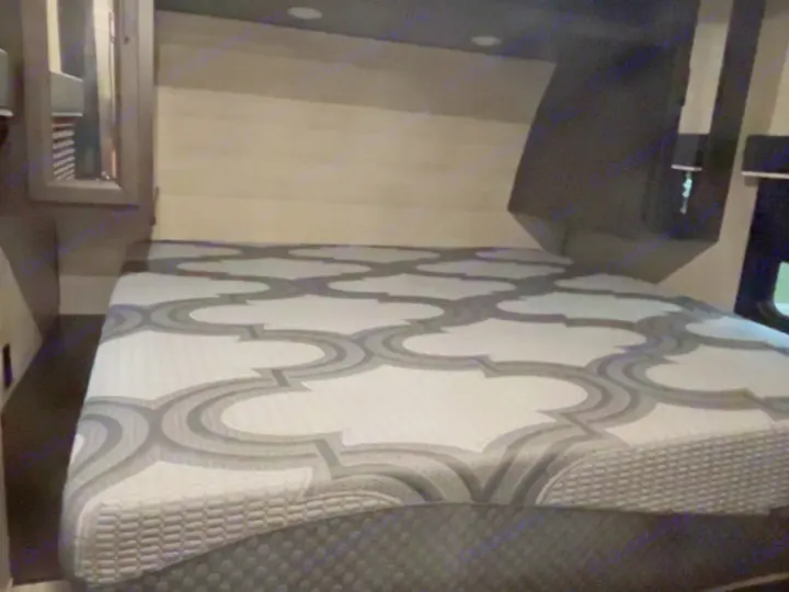 Explore this RV rental's cozy bedroom, featuring a comfortable bed with a modern patterned mattress.. Jayco Jay Flight 2023