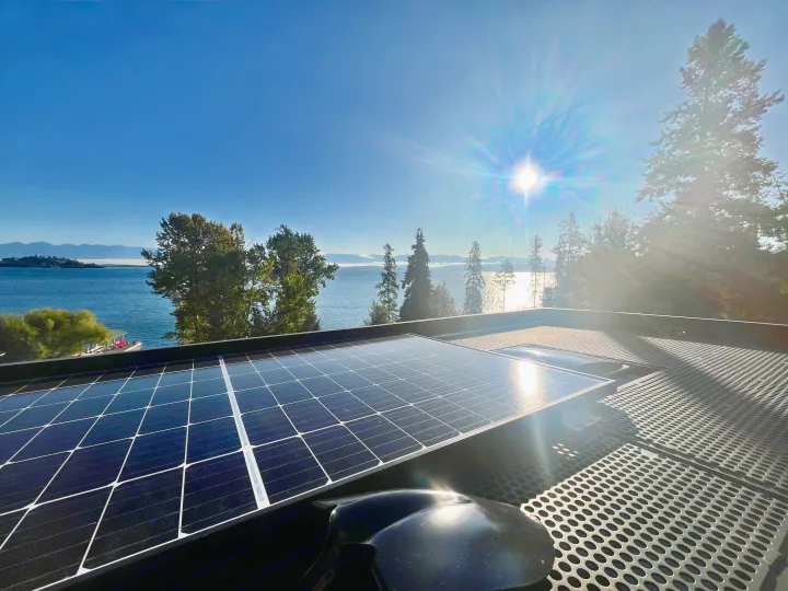 Enjoy an rv rental with rooftop solar panels, a stunning lake view, and distant mountains under a bright sun.. Mercedes-Benz Sprinter 2019