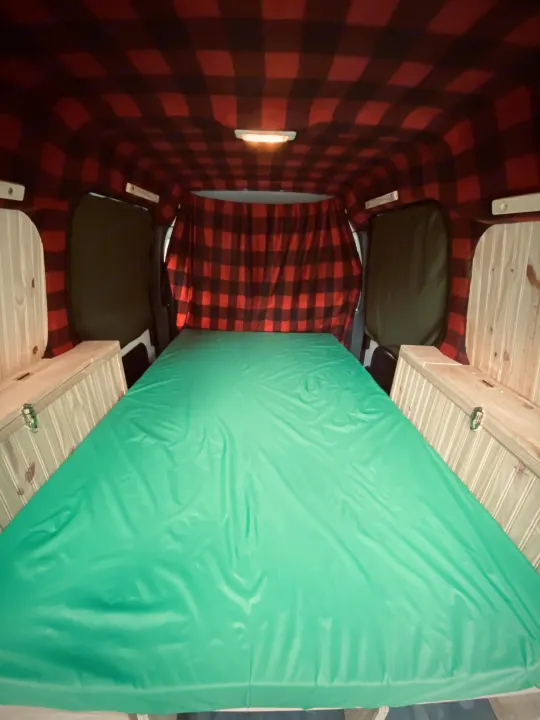 Bed flips down to full queen length when sleeping. The memory foam mattress is covered in waterproof ripstop nylon.. Ford Custom Transit 2011