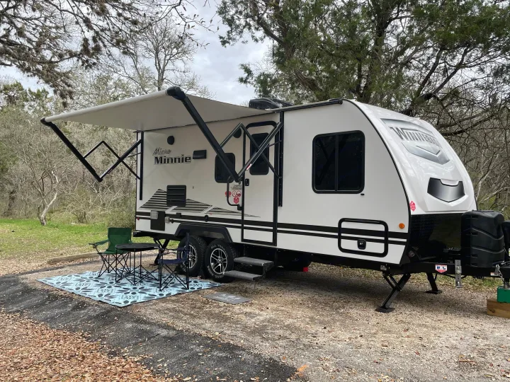 Relax under the awning with included camping chairs, camping table, and rug.. Winnebago Micro Minnie 2021