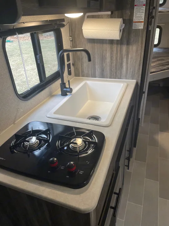 Oversize kitchen sink & double burners. Forest River Wildwood FSX 2021
