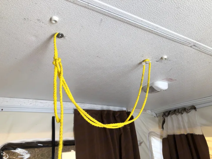 One of the factory stow hooks for the door has broken, so we've improvised with a bit or rope.  . Forest River Rockwood Freedom 2013