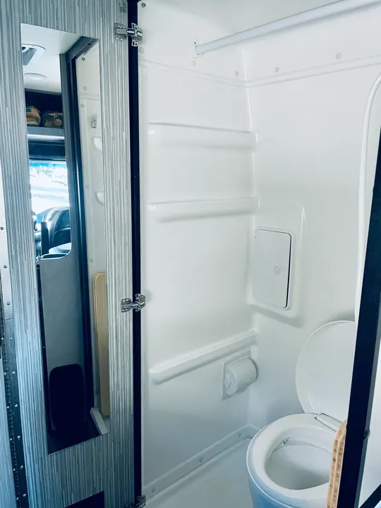 Toilet/shower combination. Nothing like a hot shower in the middle of the woods after a campfire!. Winnebago Revel 2022