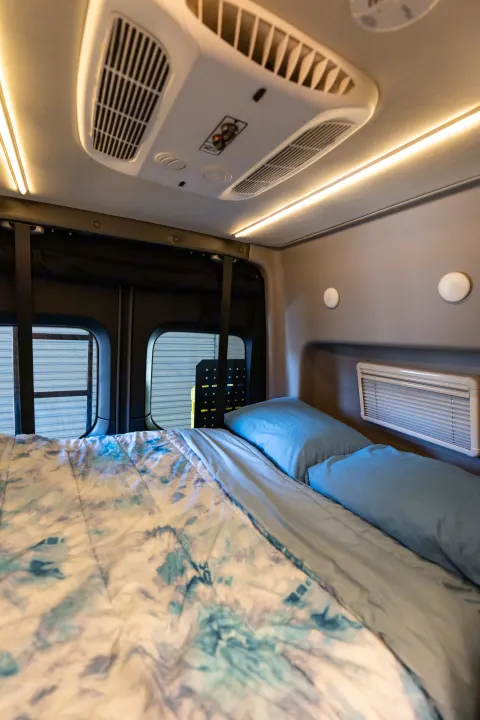 Bedroom area with vent window and reading lights. Winnebago Revel 2020