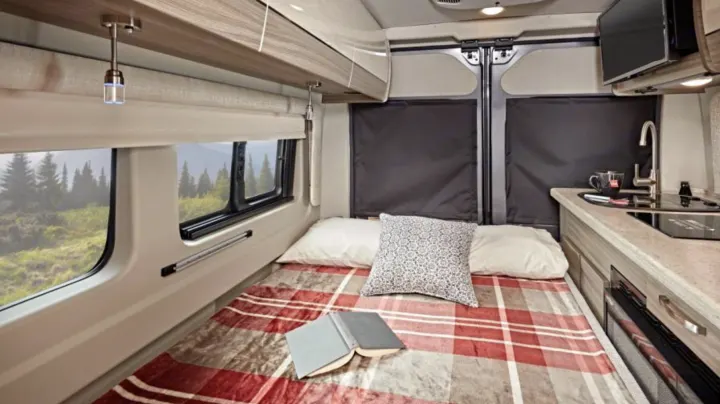 Sleeping area in the rear converted to a bed from a bench. . Entegra Coach Ethos 2023