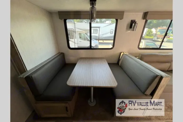 Cozy RV rental interior featuring a dinette with bench seating and table, ideal for your next travel adventure.. Forest River Palomino Solaire 2023