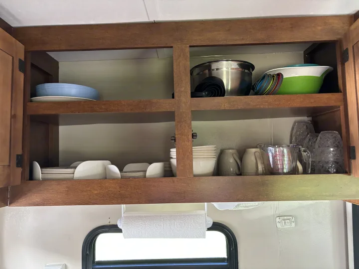 Above sink cabinet with service for 6, misc. kitchen items needed for cooking & storage.  All utensils, dishtowels, paper towels. Coachmen Catalina Deluxe Edition 2013