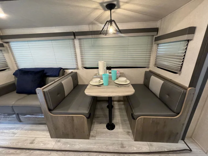 Storage under dinette includes DVDs, board games, dog bowls, and additional bedding.. Forest River Surveyor Legend 2022