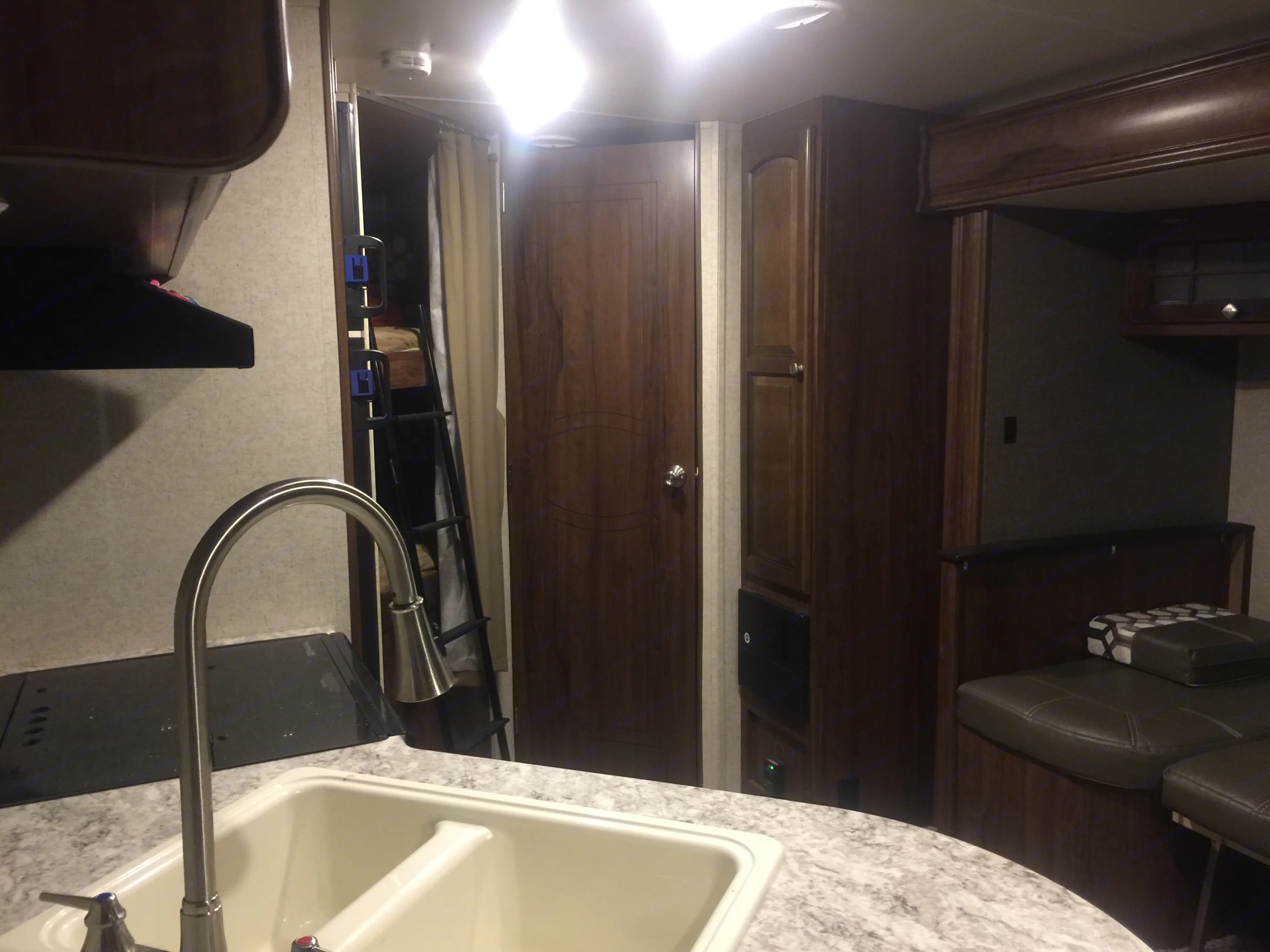 Well-equipped RV rental: kitchen sink, bunk beds, and comfy dining area visible. Perfect for travel on the go!. Other North Trail 2017