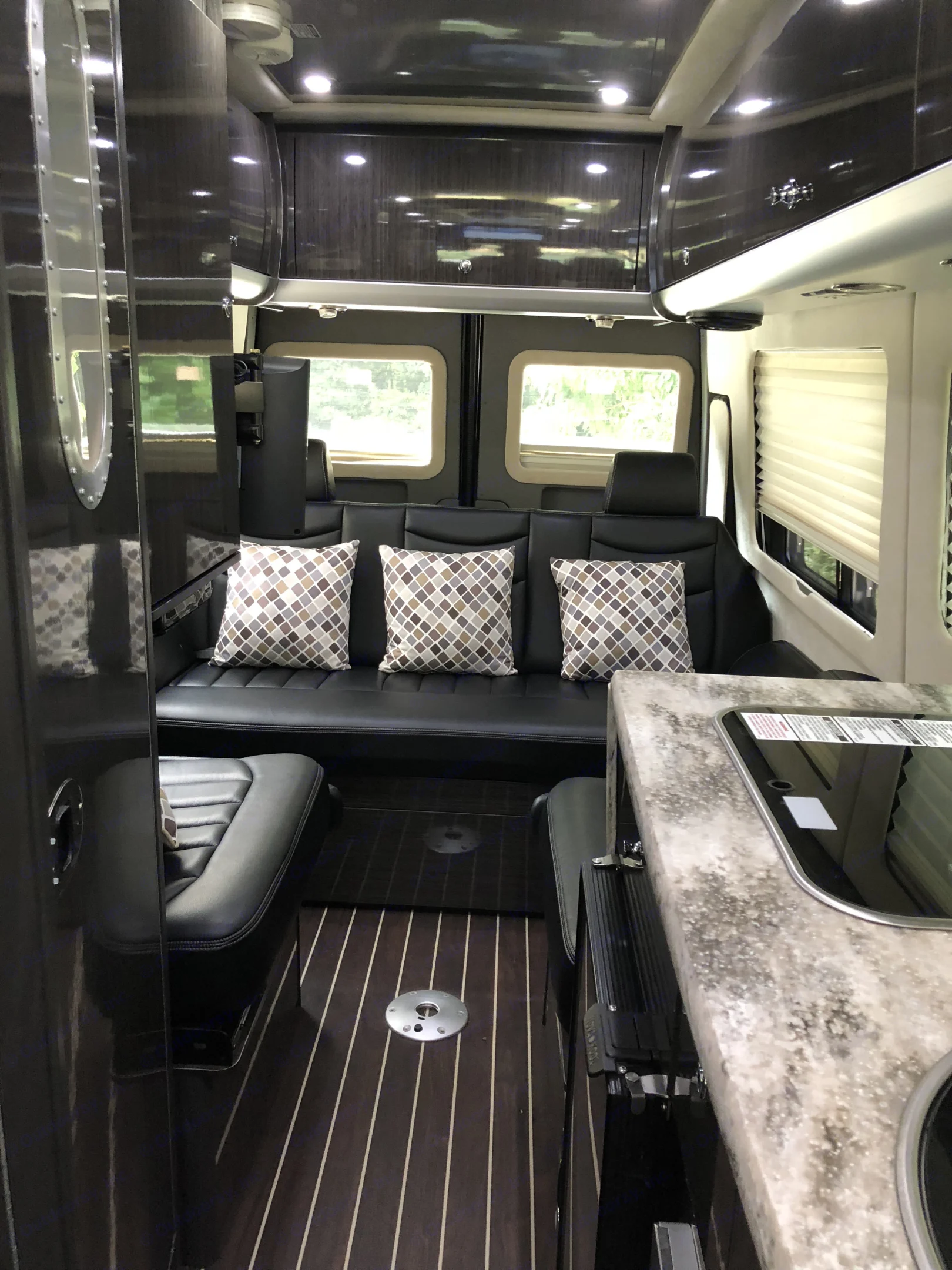 Bench seating for four, plus oversized ottoman . Airstream Interstate 2014