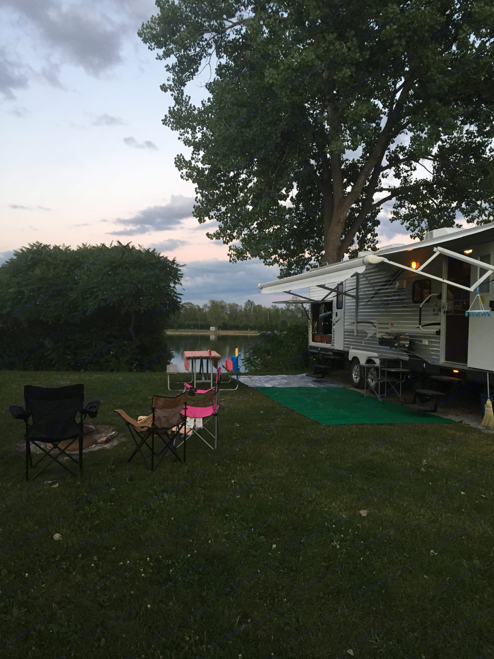 Exterior. Pictured are two entrances (one to the bathroom), outdoor kitchen and awning.. Jayco Jay Flight 2012