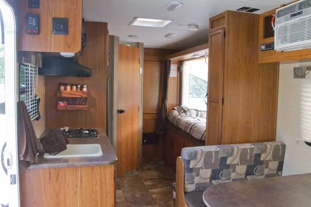 View from door to rear of unit. Kitchen, bathroom (door closed) closet with hang rod for clothing, queen bed, pantry, dinette. . Starcraft Launch Extreme Hybrid 2015