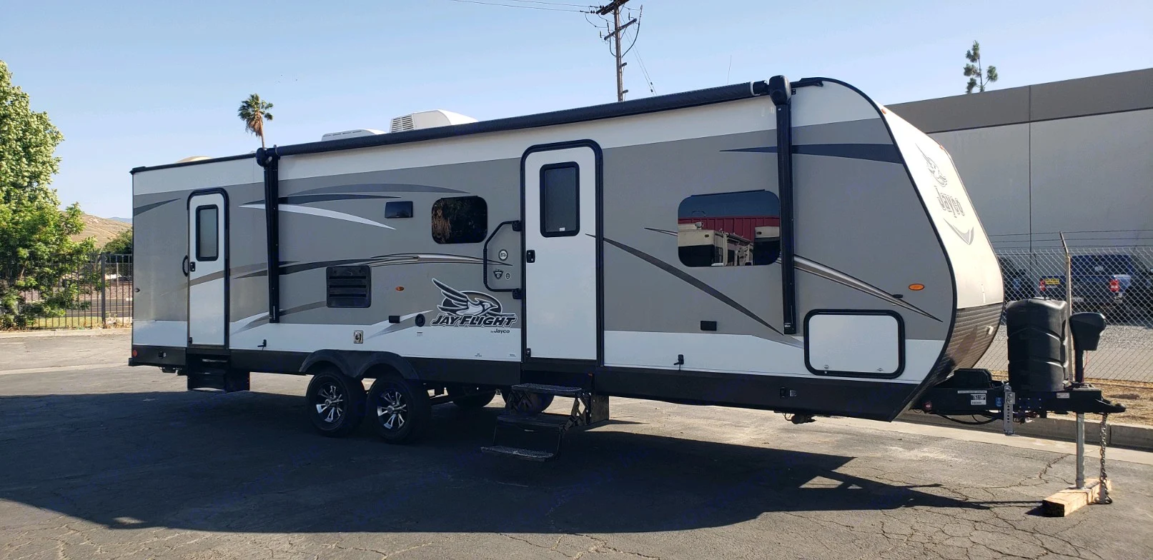 A gray and white Jayco Jay Flight travel trailer parked, ready for your next rv rental trip.. Jayco Jay Flight 2019