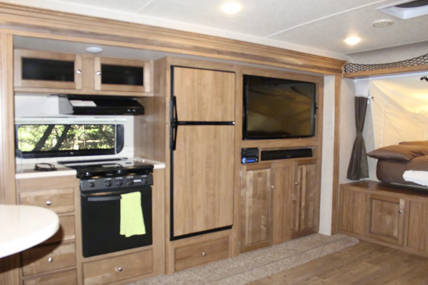 Kitchen has a 4 burner propane stove and a 2 shelf propane oven. The refirgerator can be run on propane or electric. Large 2 basin sink. . Forest River Rockwood Roo FL 2018