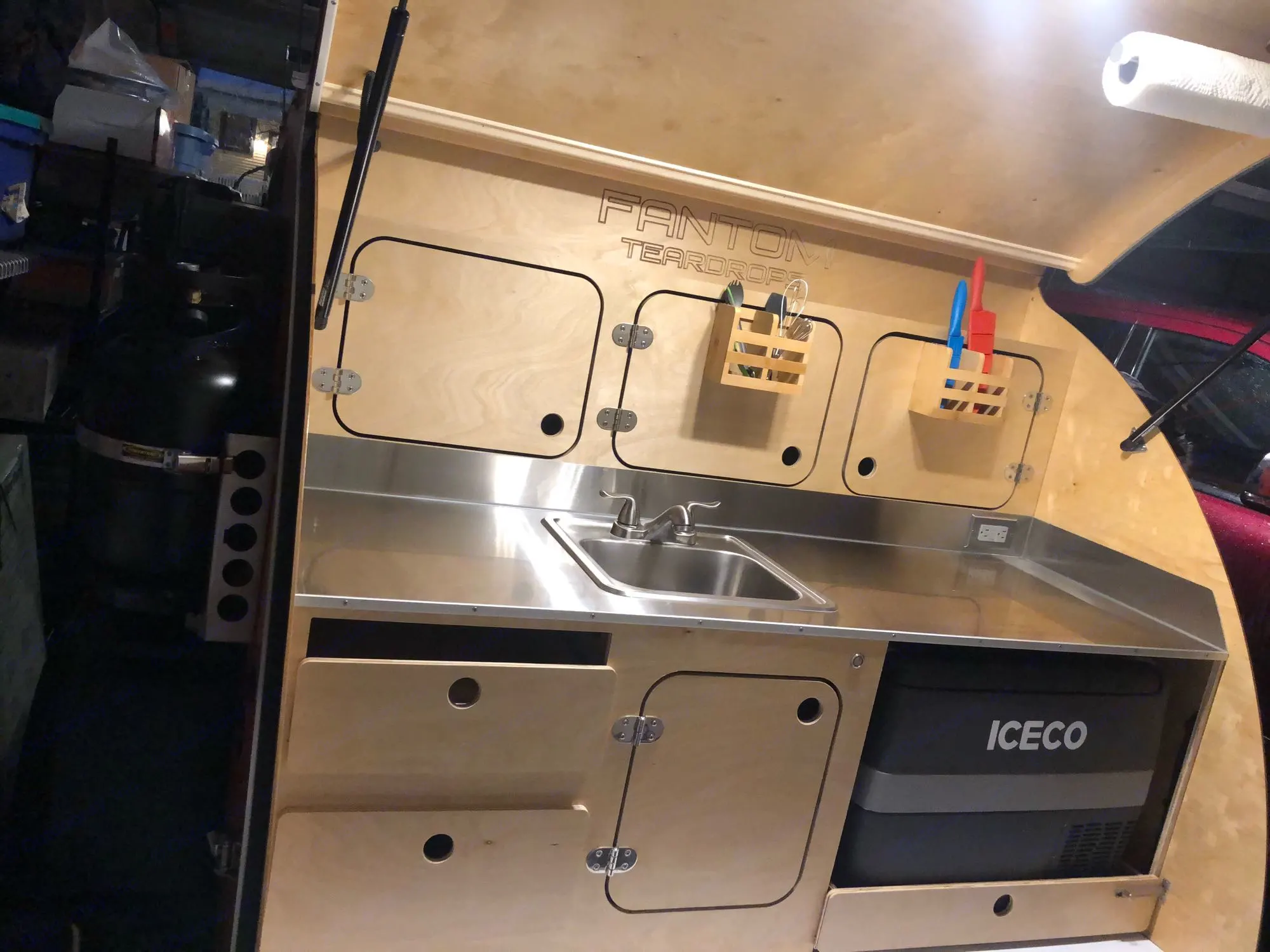 The galley kitchen features a propane powered hot and cold water sink, an Iceco fridge, stainless steel countertop, storage cabinets and drawers.. Other Other 2021