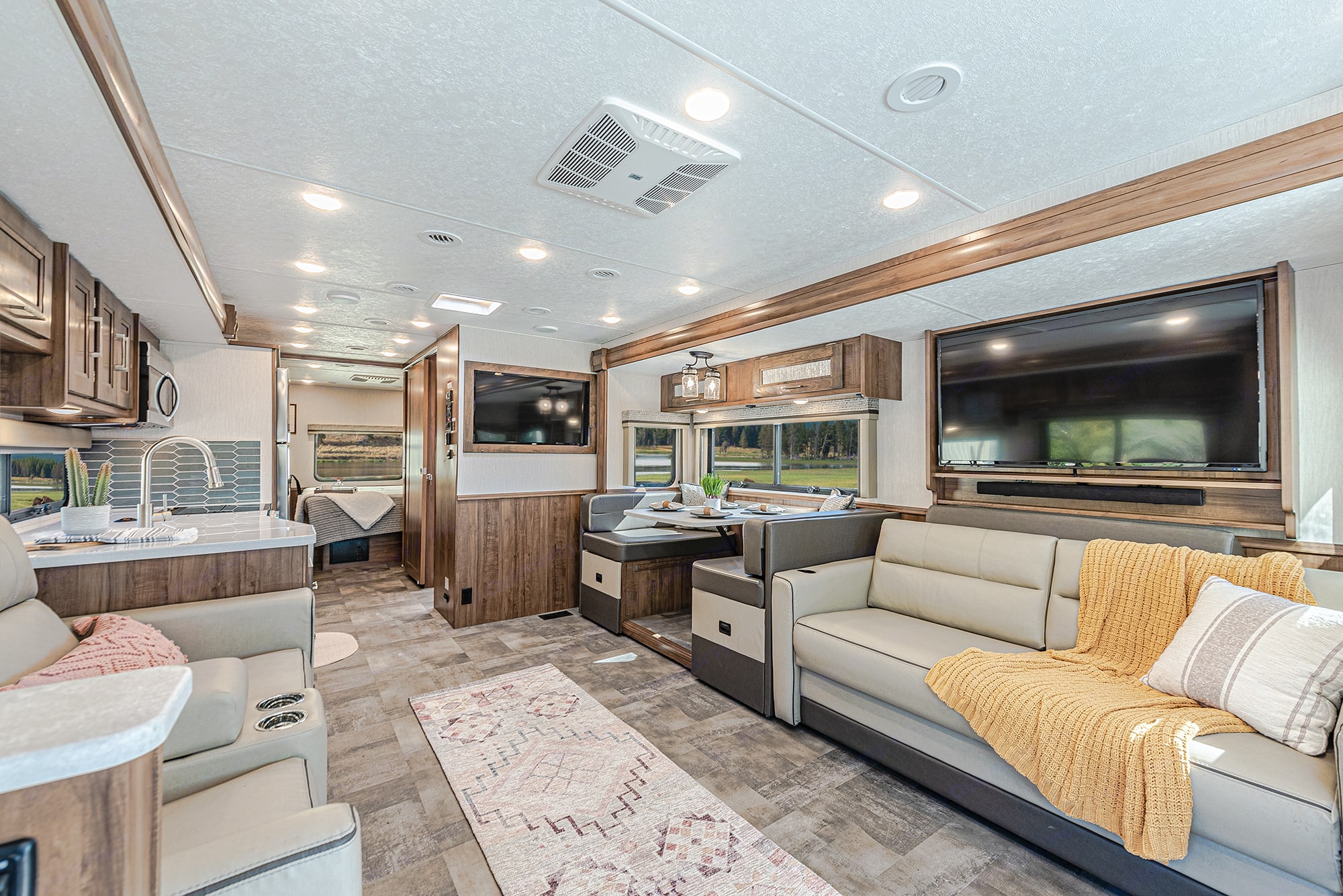 Explore this spacious, modern RV rental interior, featuring living, dining, and kitchen areas for comfortable travel.. Coachmen Mirada 2021