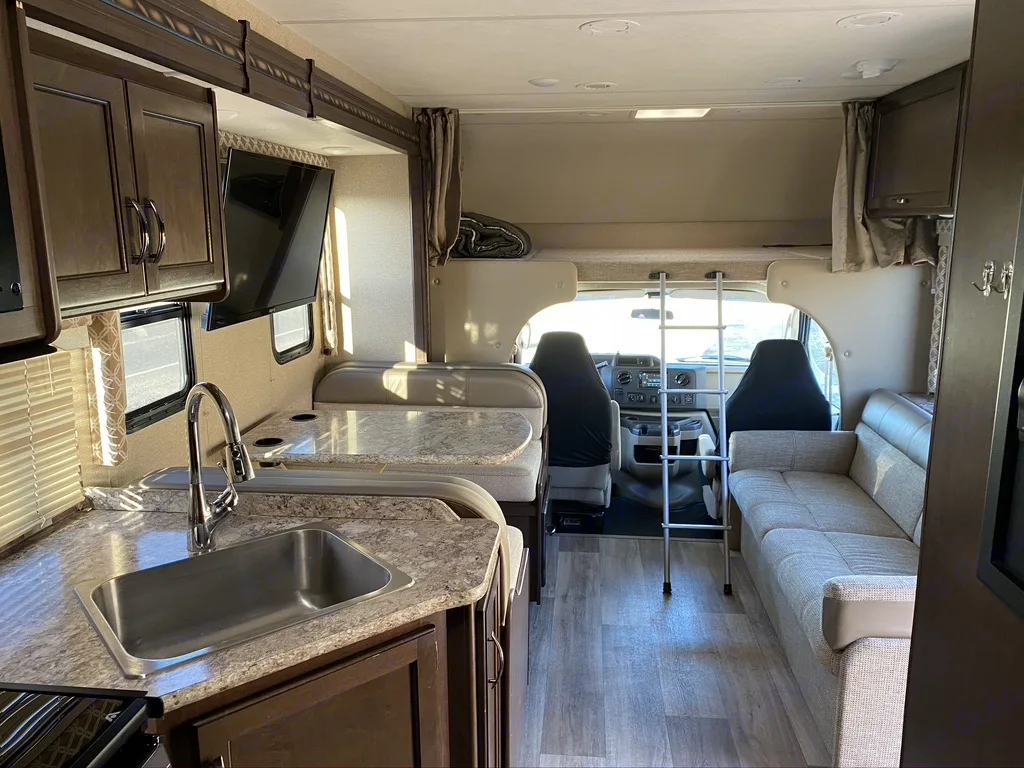 View of the kitchen, dining area, couch, bunk and cab.. Thor Freedom Elite 2018
