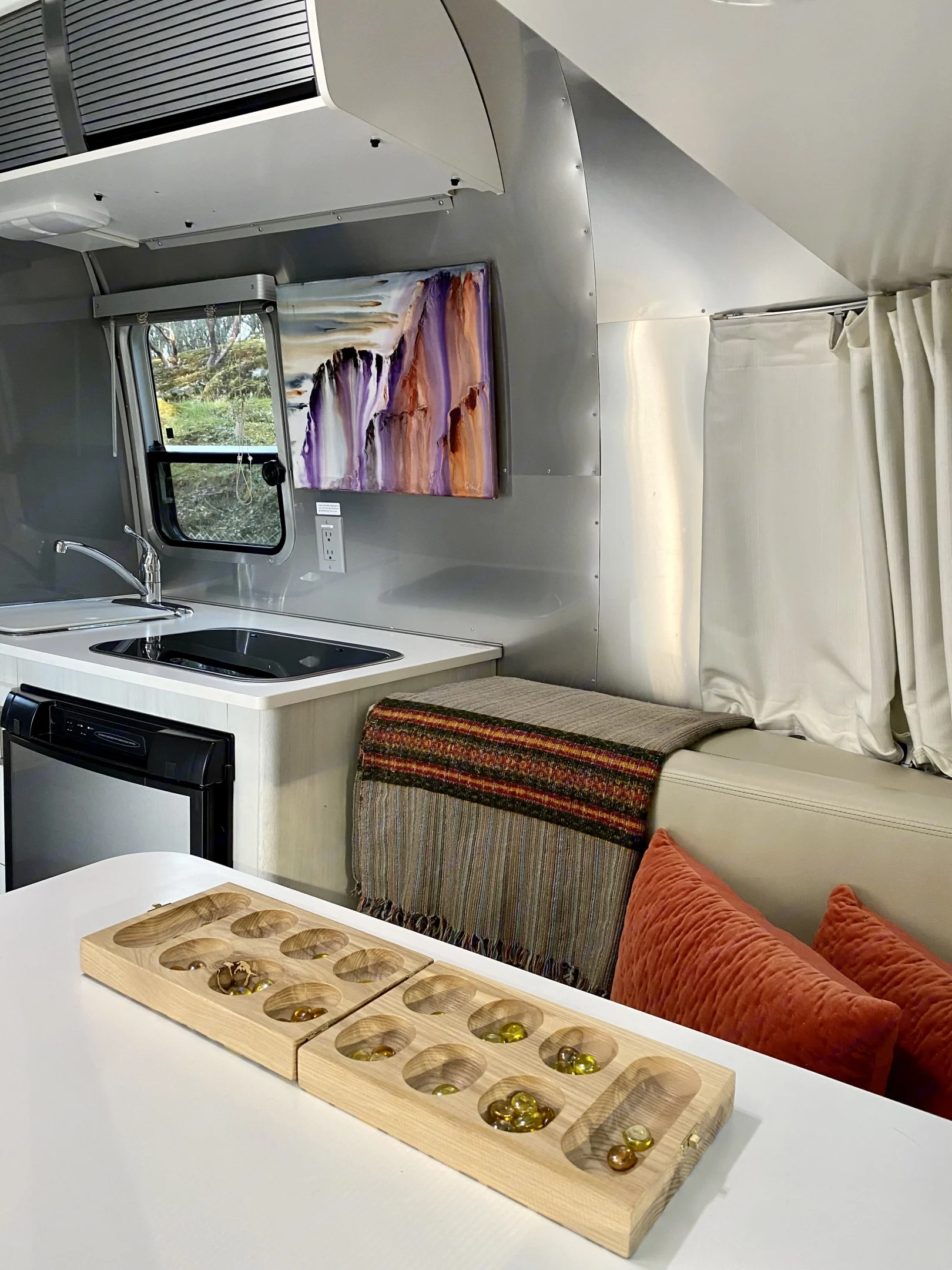 Time to chill in the Airstream after a day of exploring... books, mancala, journaling, scrabble, or maybe planning your next adventure?. Airstream Sport 2016