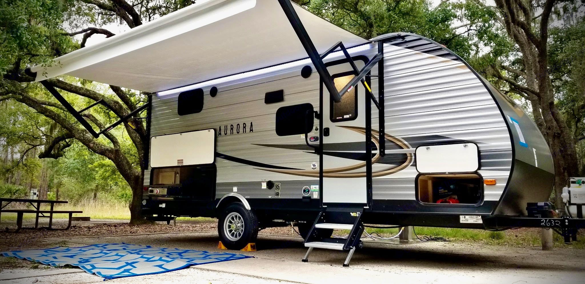 Sure Steps, electric awning with LED lighting, outdoor griddle with extra fridge. Forest River Aurora 18BHS 2021