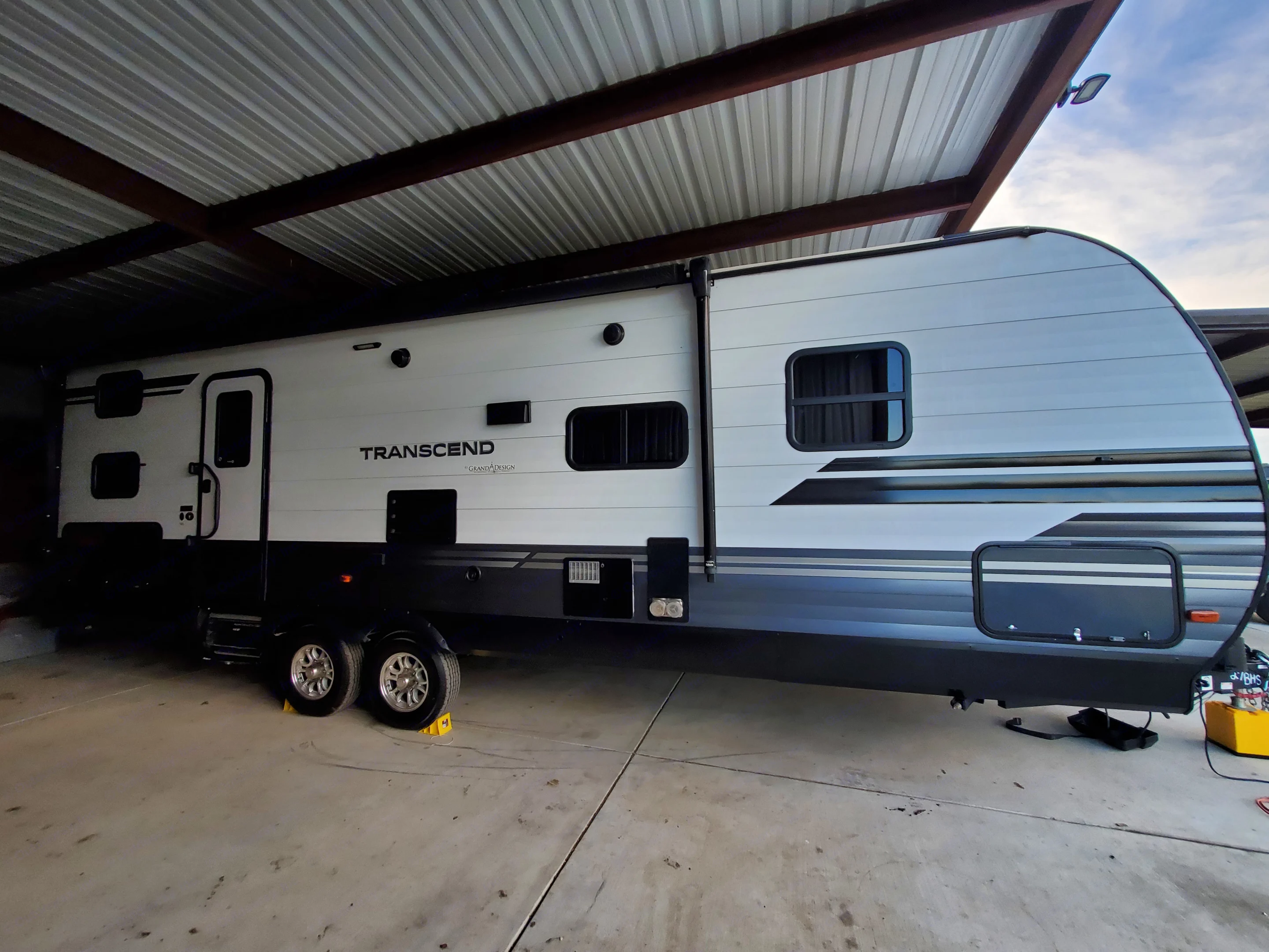 Grand Design Transcend RV rental parked under a metal canopy, showing. Grand Design Transcend 2019