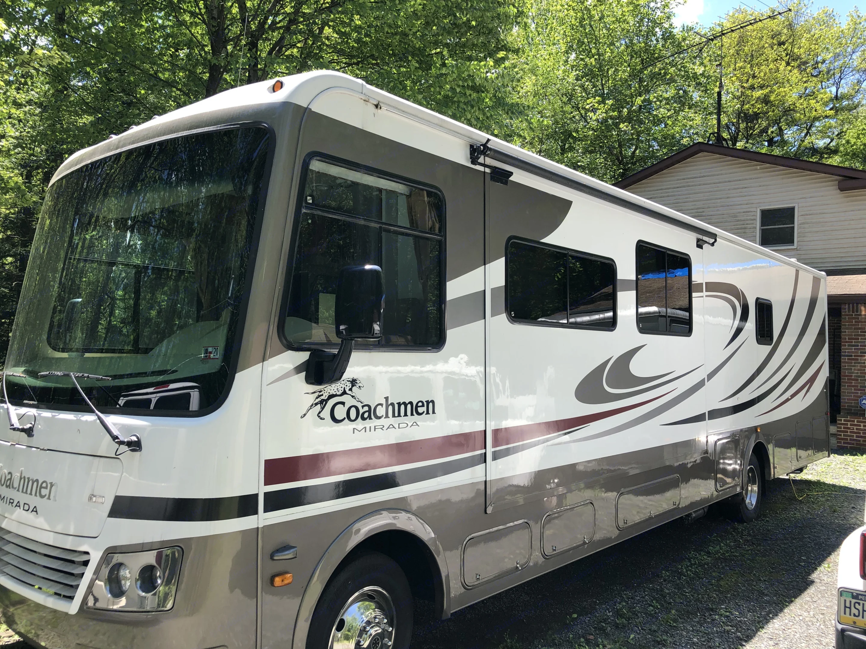 large view of road and surroundings with 1 piece windshield and side windows mirrors . Coachmen Mirada A-Class 2011
