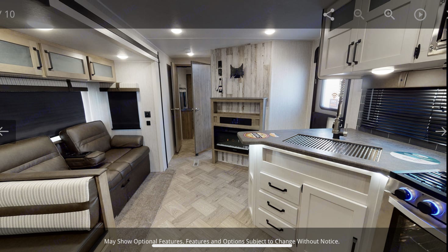 Explore this modern RV rental interior featuring a comfy living space, kitchen with sink, and fireplace unit for a great trip.. Forest River Puma 2021