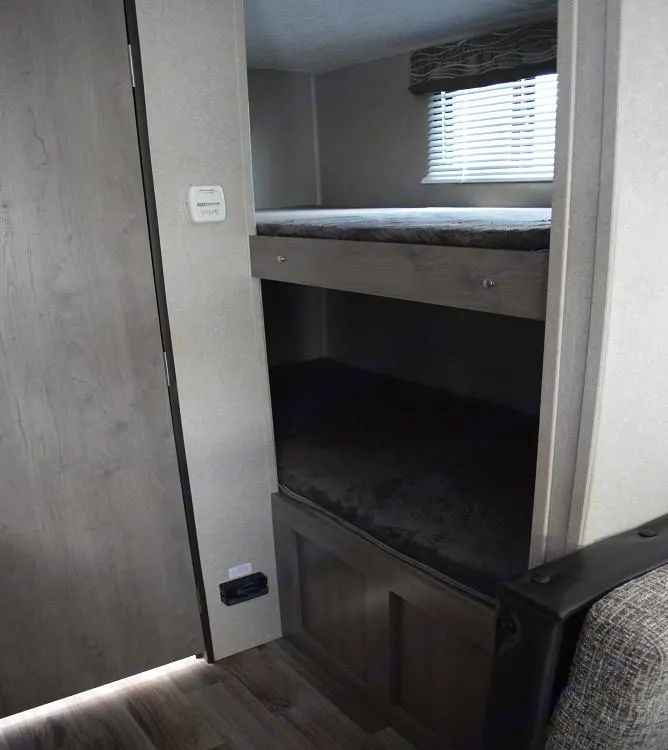 RV rental interior: Two bunk beds offer cozy sleeping space, viewed from a hall. Forest River X-Lite 2020