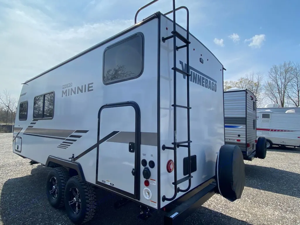 Winnebago Micro Minnie travel trailer for RV rental, showcasing its rear ladder, spare tire. Winnebago Micro Minnie 1800BH 2022