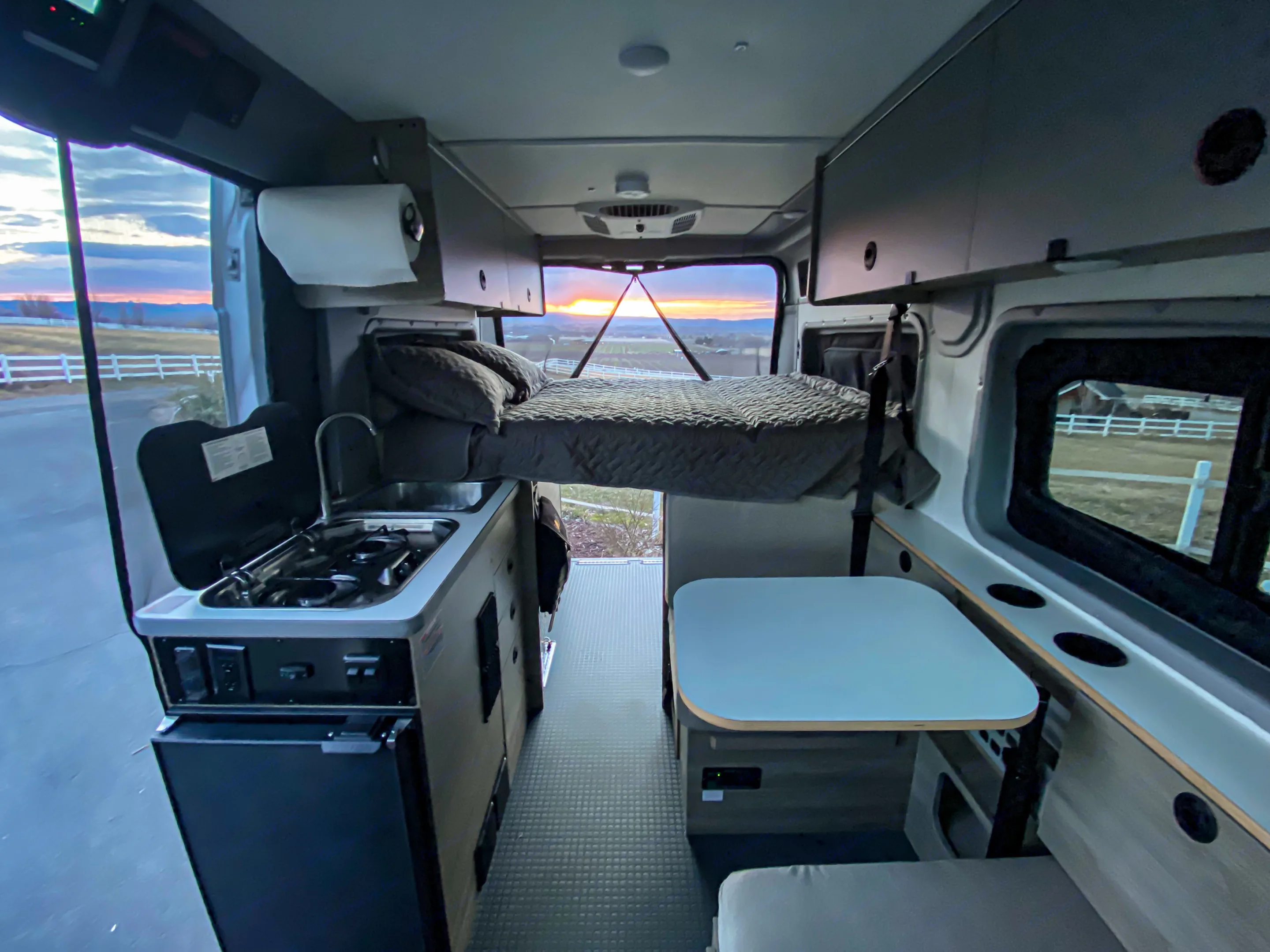 Full bed in sleeping position. Interior living area. Dinette converts to second sleeping area. Full bug netting to all doors and entries. . Winnebago Solis Pocket 2022