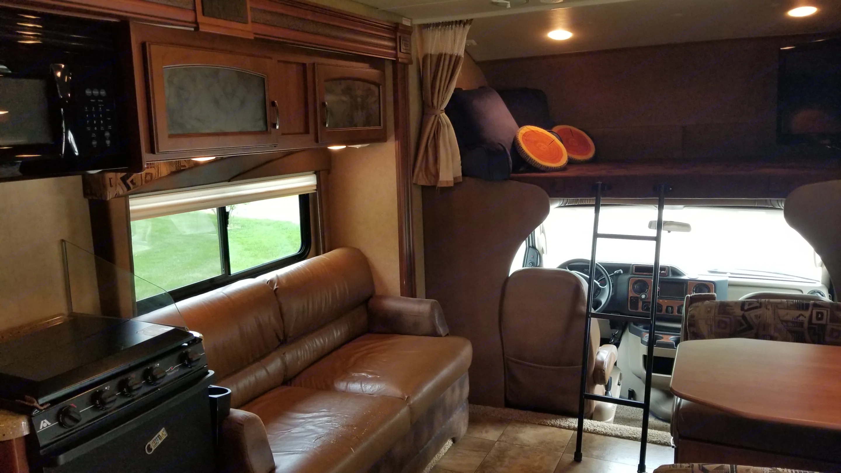 Step inside this comfortable RV rental, featuring a full kitchen, sofa, dining booth, and bunk bed for your travels.. Jayco Greyhawk 2013