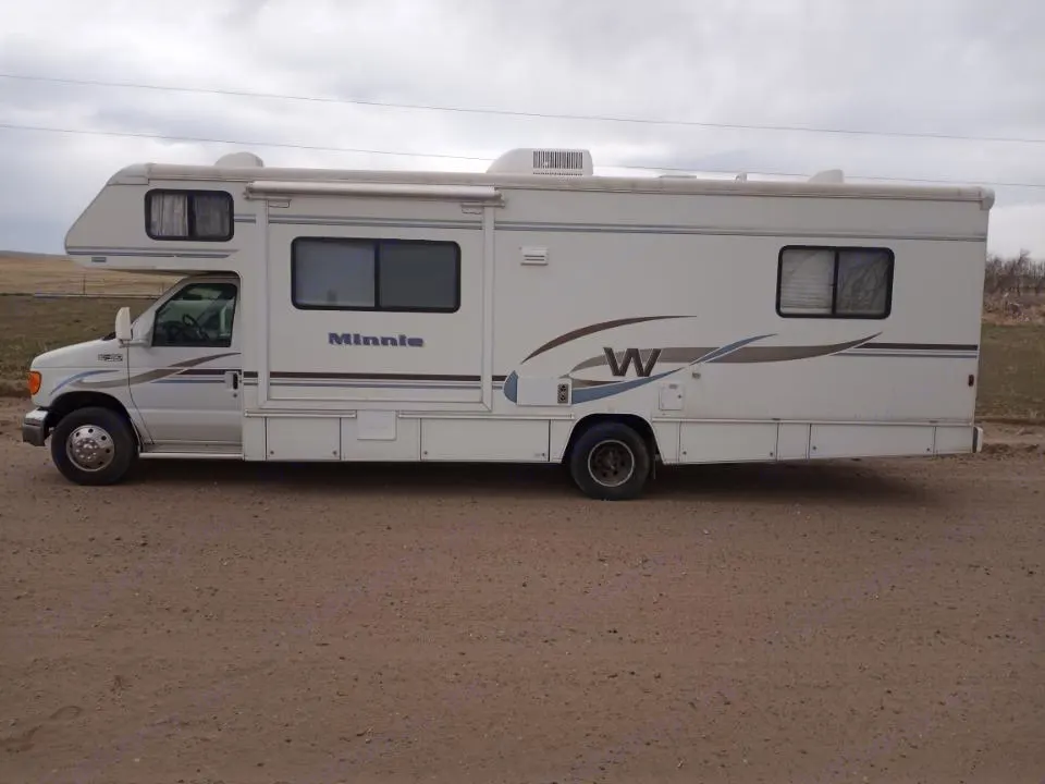 Driver side exterior, before navigational cameras were installed.. Winnebago Minnie 2004