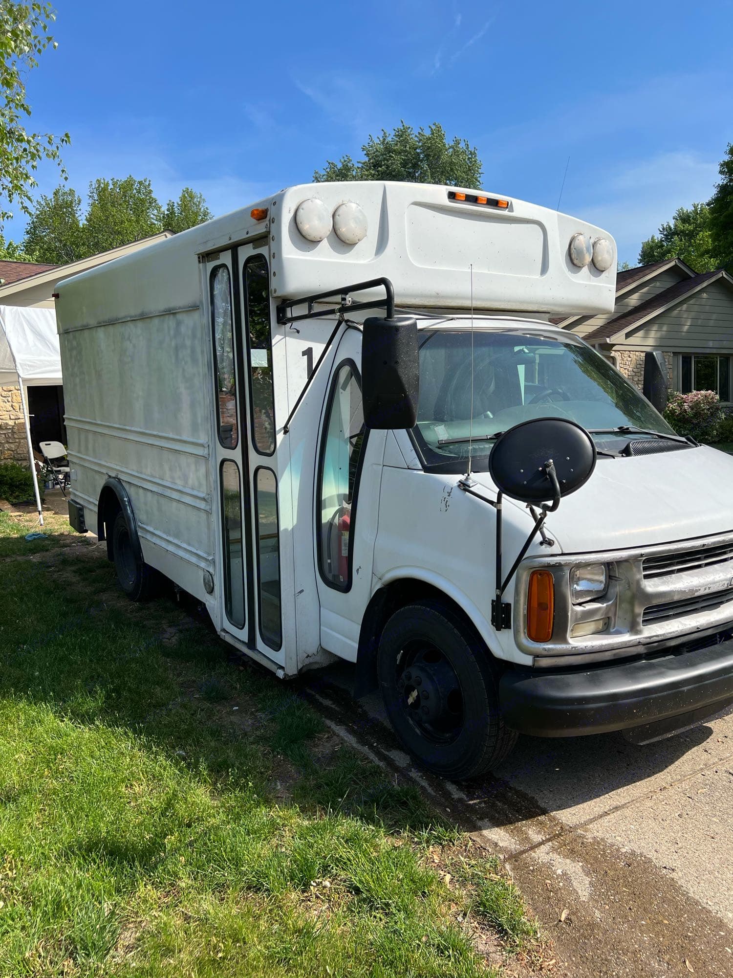 White converted shuttle van, ideal for RV rental. This camper van is parked & ready for your next adventure.. Chevy Express 3500 Mini Bus 2002