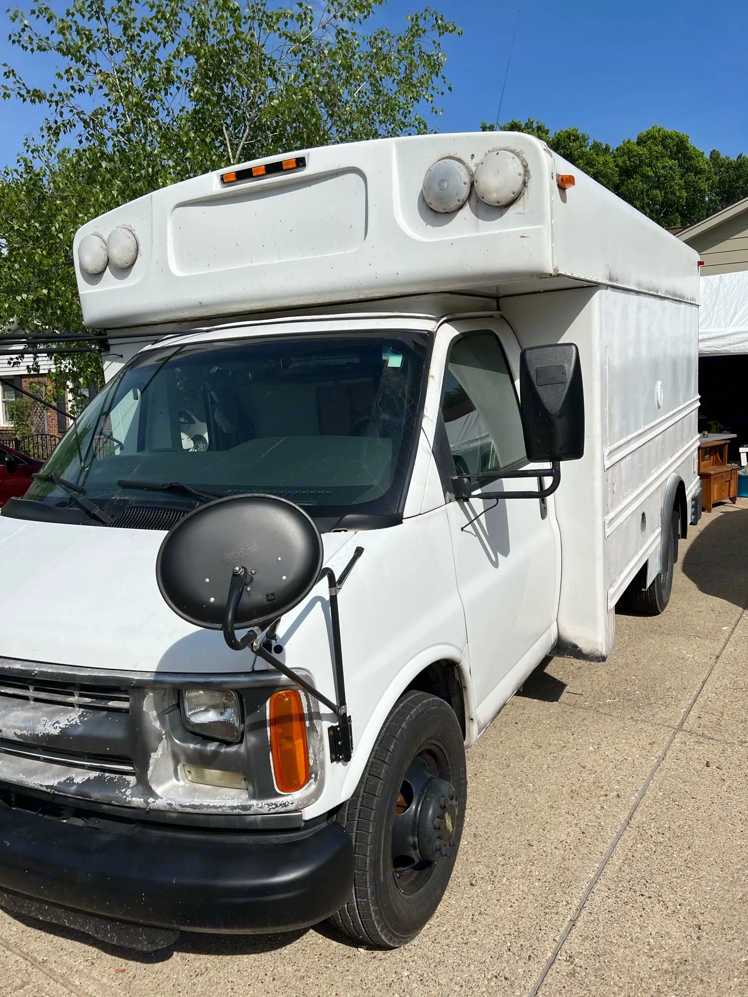 White commercial van, ideal for rv rental conversions, with extended roof and large front mirror, parked on a sunny driveway.. Chevy Express 3500 Mini Bus 2002