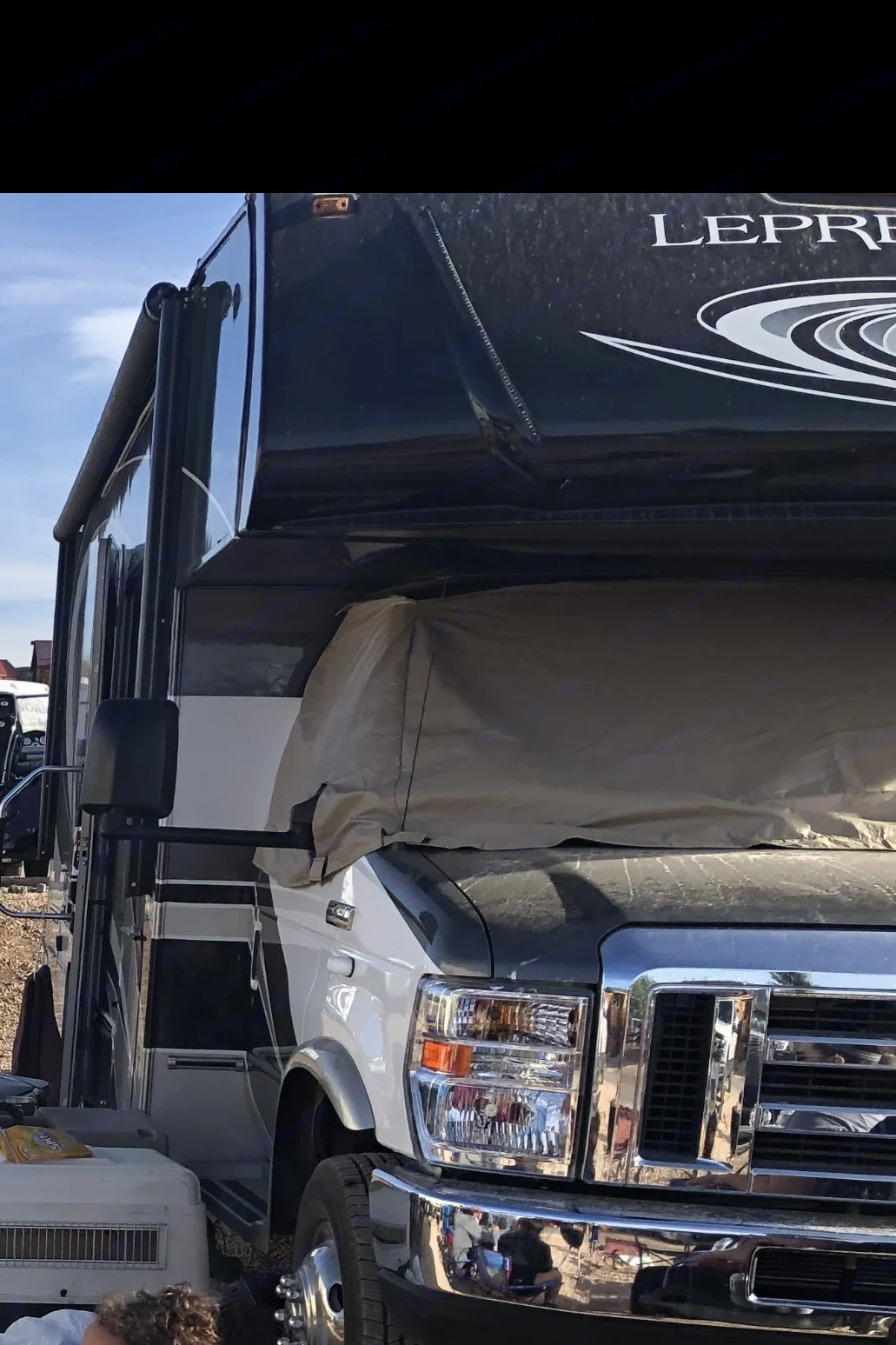 A tan-covered Ford Class C rv rental, parked outdoors. This motorhome offers comfortable travel and camping experiences.. Coachman Leprechaun 260DS 2017