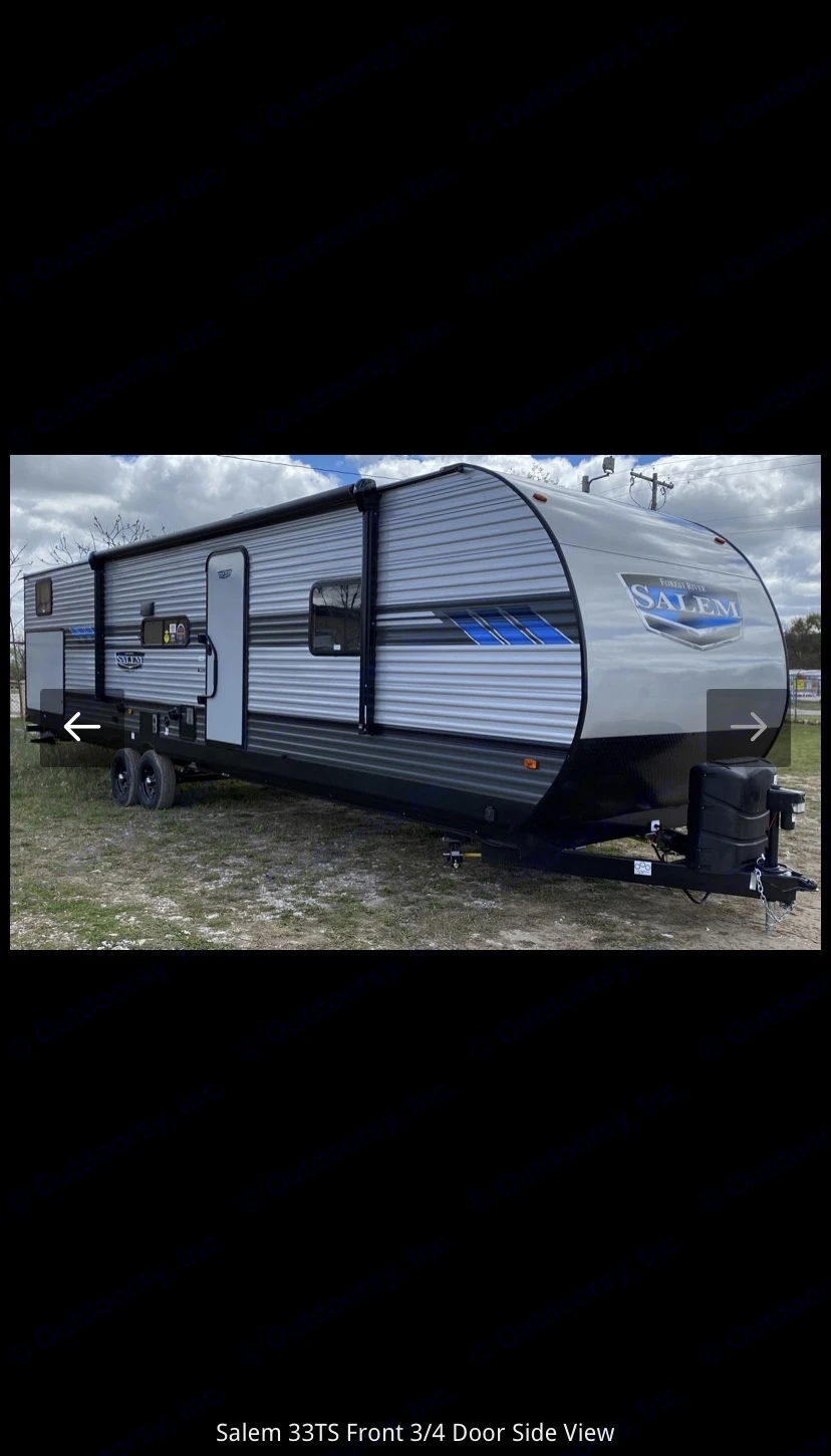 Grey Salem 33TS travel trailer (RV) with blue accents, ideal for rv rental. Seen front 3/4 view parked on grass.. Forest River Salem 2022