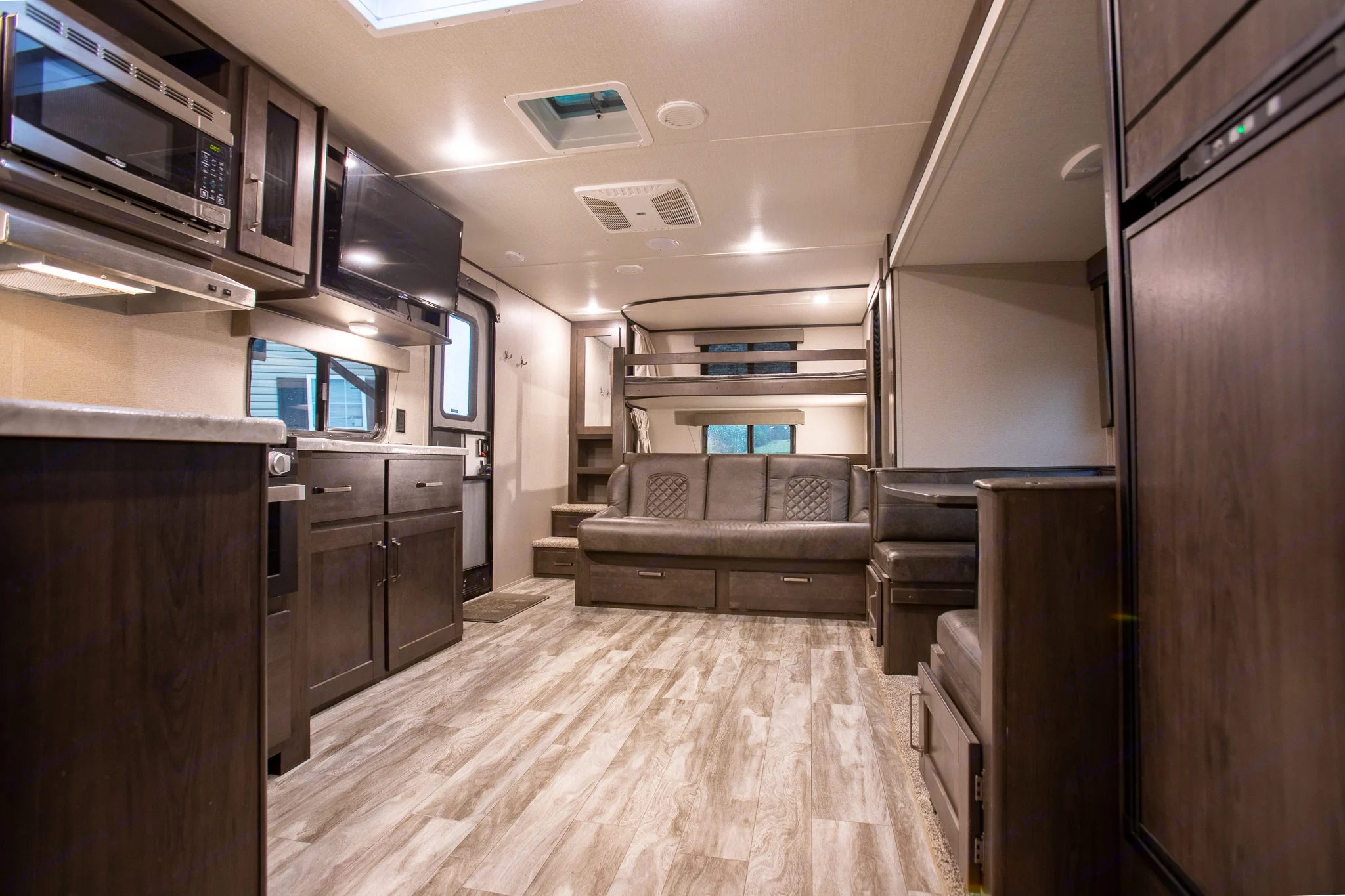 Inside a comfortable RV rental: kitchen,. Grand Design Transcend Xplor 2021