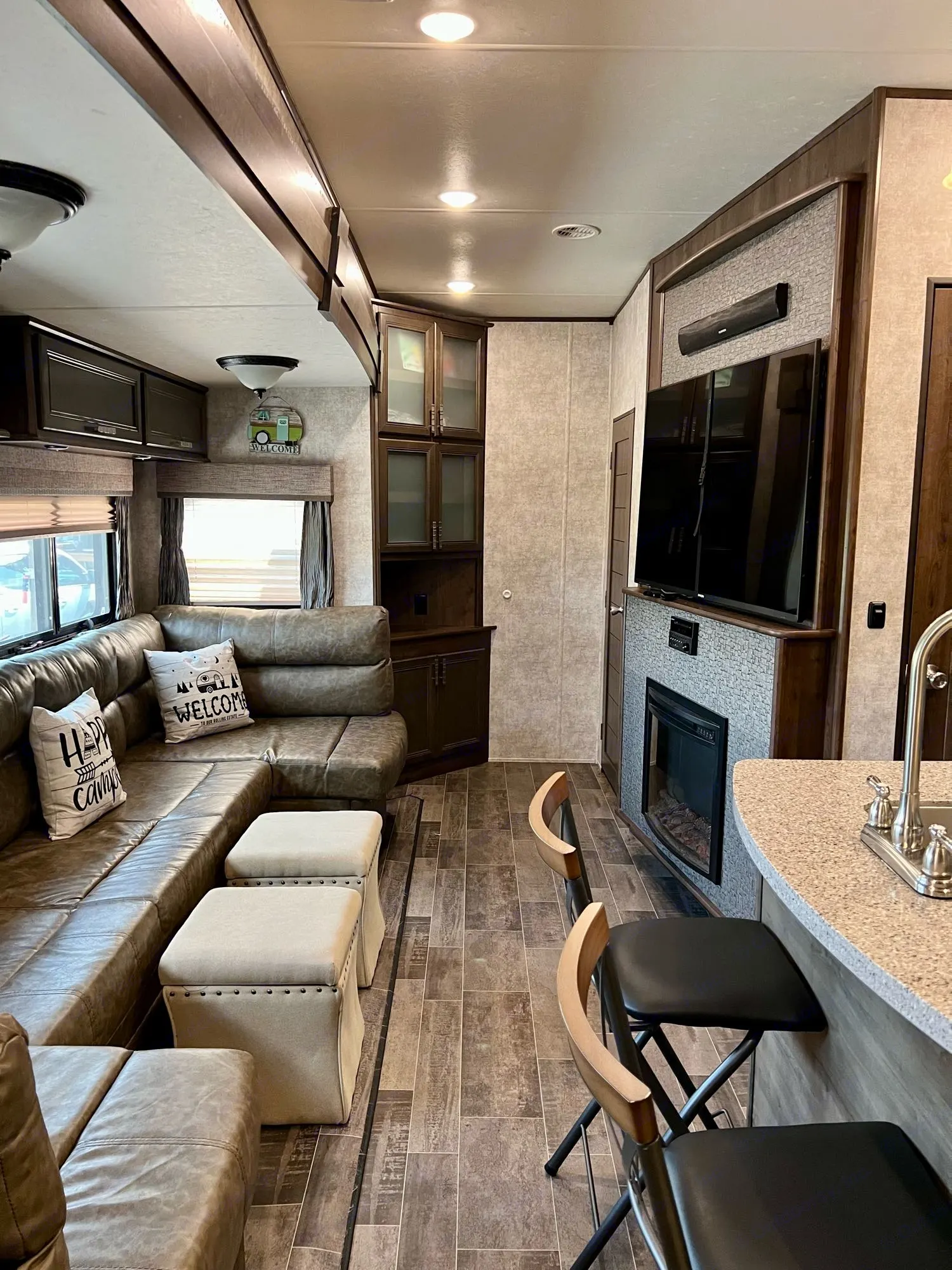 Spacious living room with large couch that makes into a queen size bed.. Highland Ridge RV Roamer 2017
